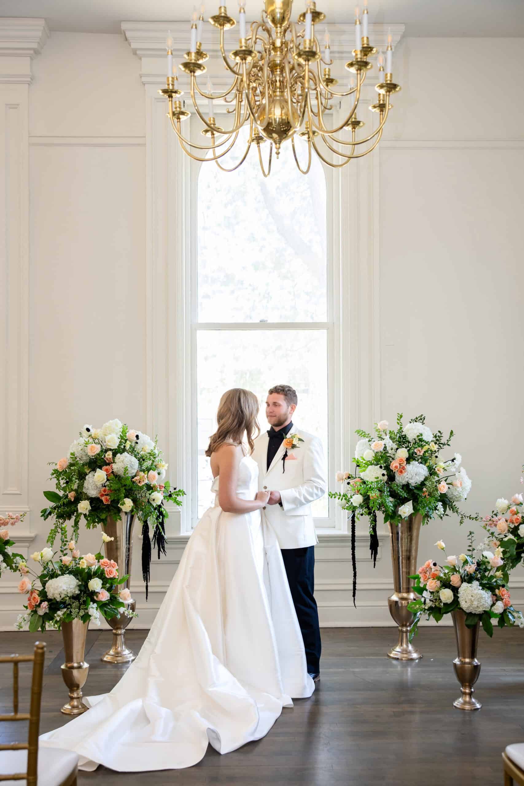 Bride and groom exchanging vows in a beautifully decorated wedding venue.