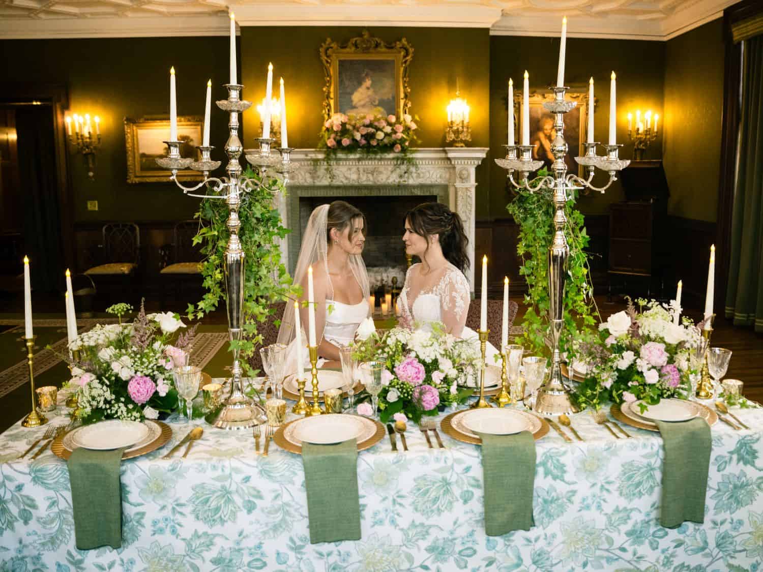 Beautiful wedding reception table with floral arrangements and candelabras.