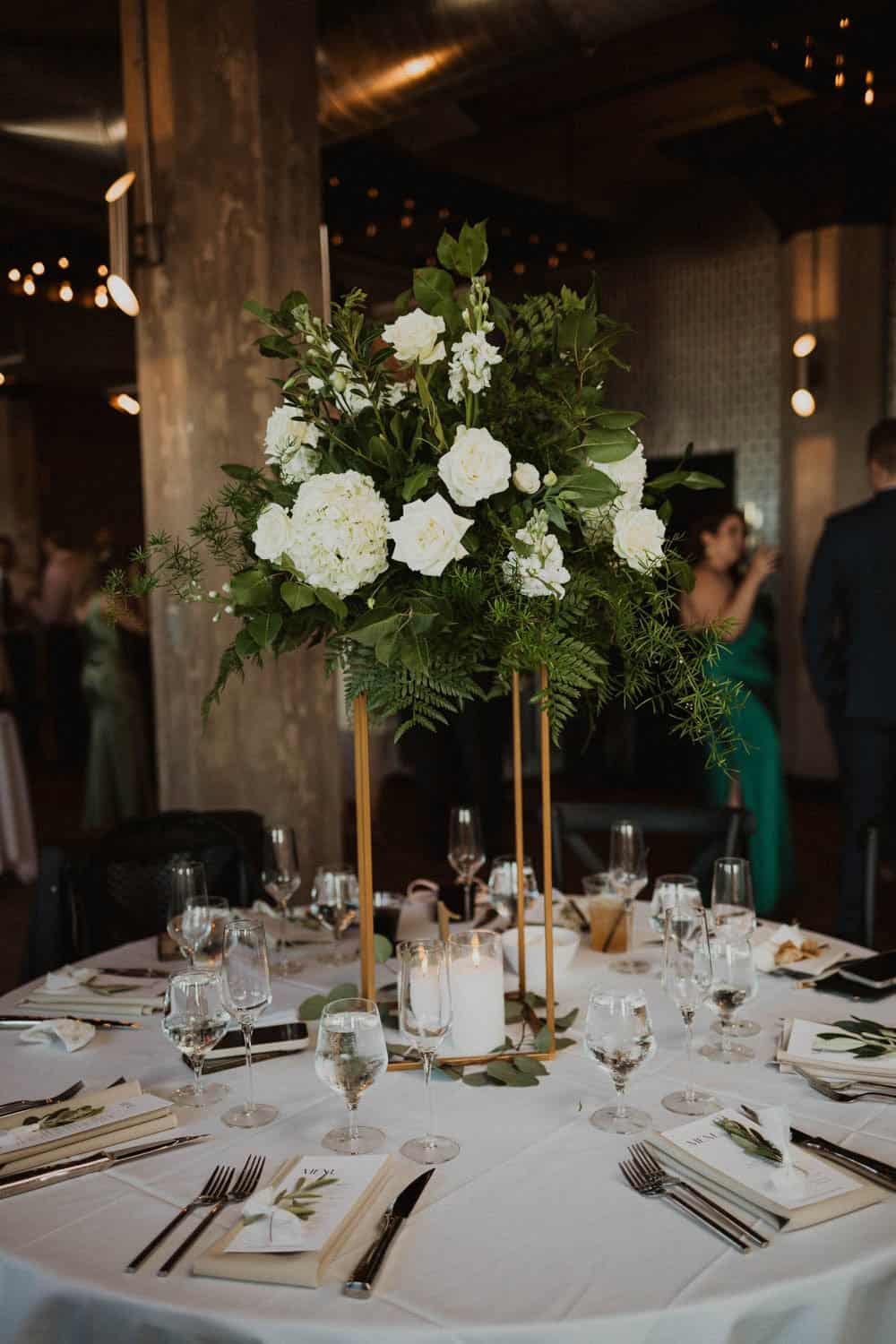 Beautiful floral centerpiece with white flowers and greenery for wedding decor.