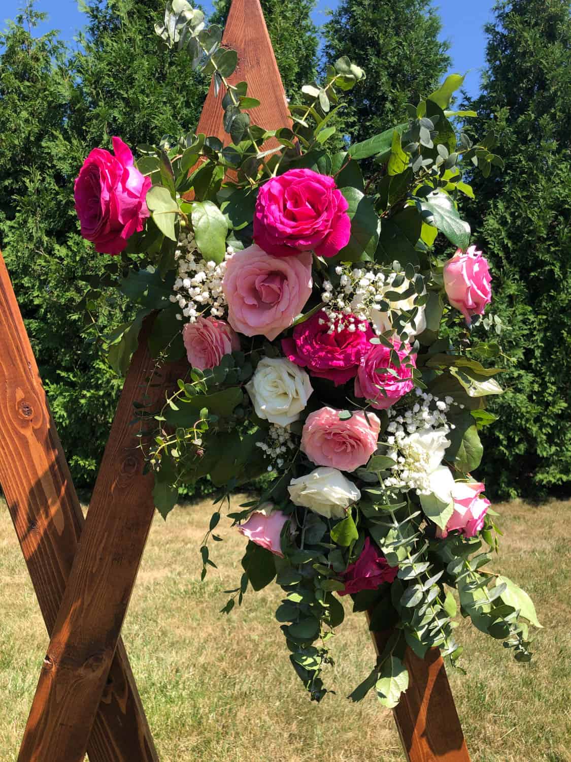 Beautiful pink and white roses with greenery for wedding decoration.